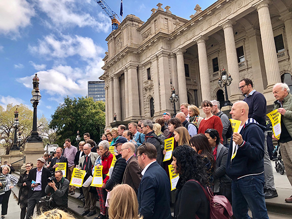 People gathered on steps of Parliament House to protest gambling.