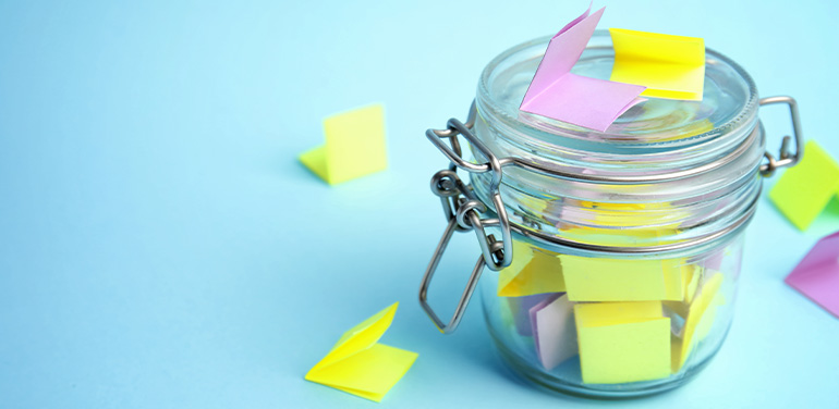 colourful post-its in a jar