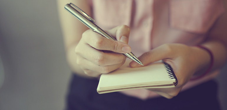 close up of a journalist holding a notebook