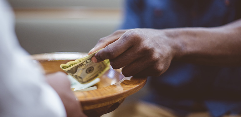 Closeup shot of a male donating money