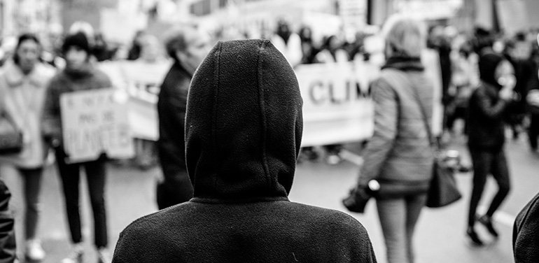 Silhouette looking at crowd marching