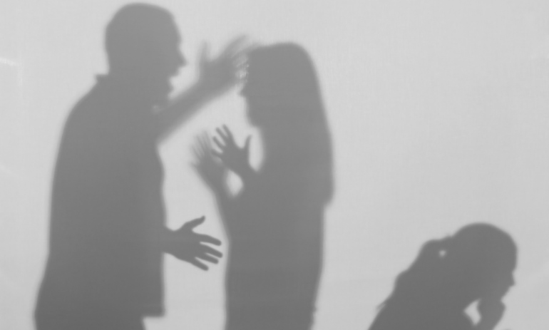 Silhouettes of quarrelling parents and little child on white background.