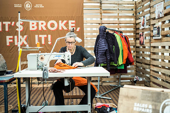 woman sewing as part of Patagonia's Worn Wear program