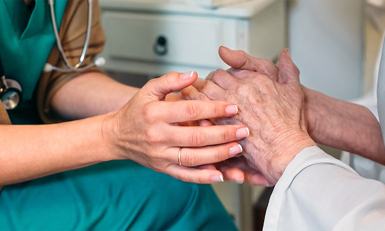 close up of hands, aged care worker supporting patient