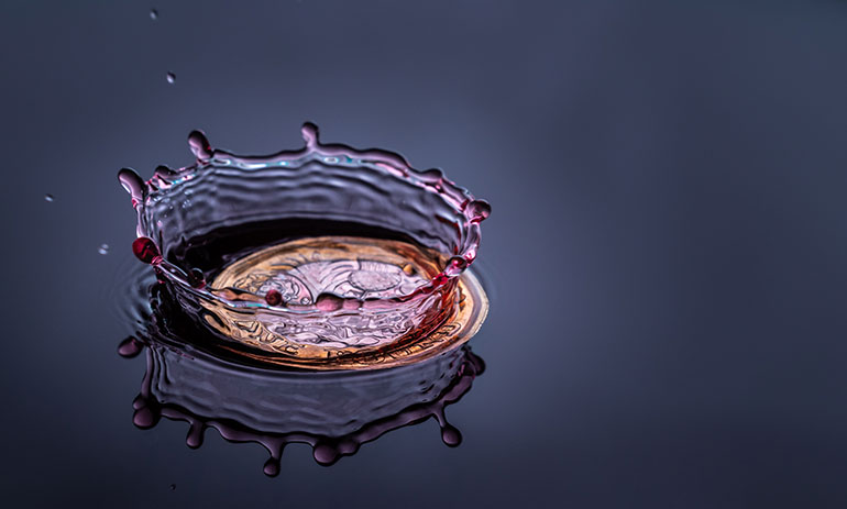 a coin splashing in water