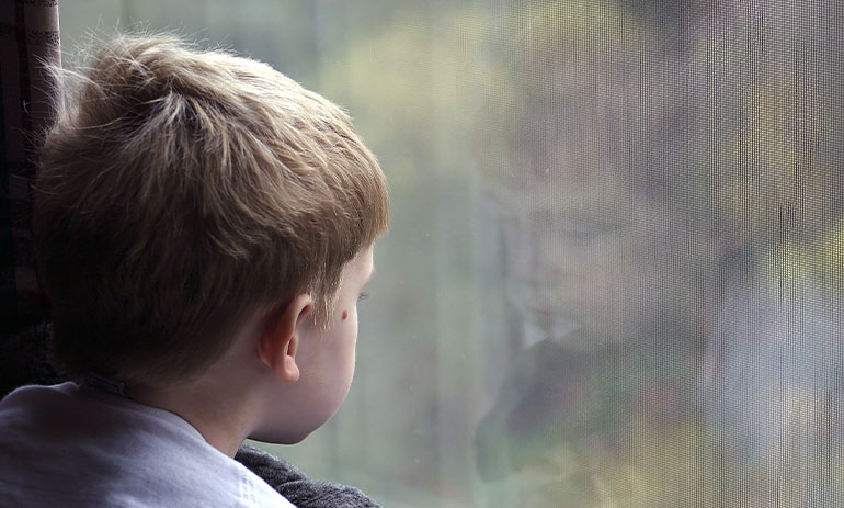 child looking out of a window