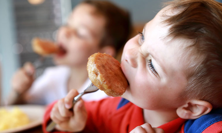 close up of kids eating