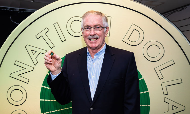 Royal Australian Mint CEO, Ross MacDiarmid, holding the Donation Dollar