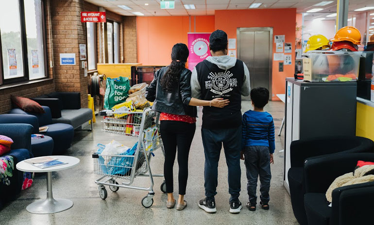 family standing with trolley at the ASRC