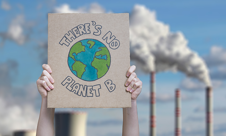 cardboard sign saying There's no planet B