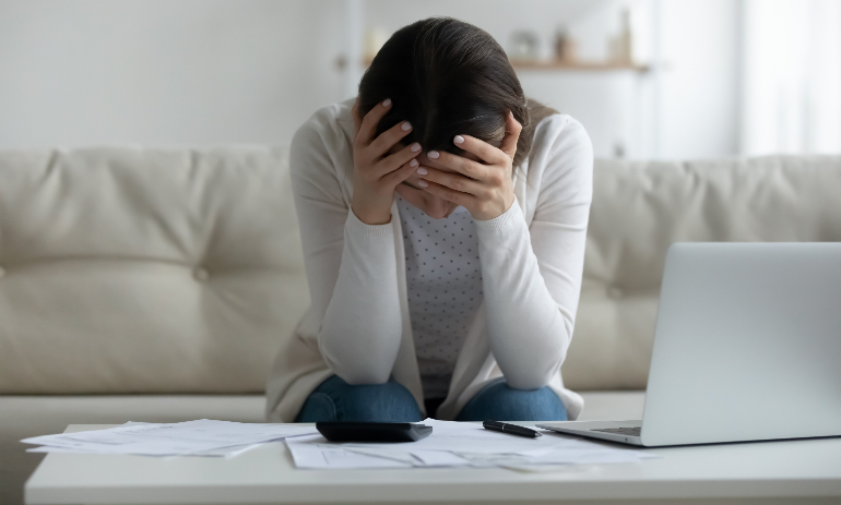 Stressed woman paying bills