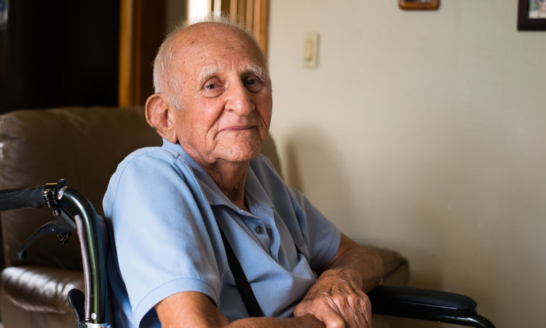 elderly man sitting in a wheelchair in his home