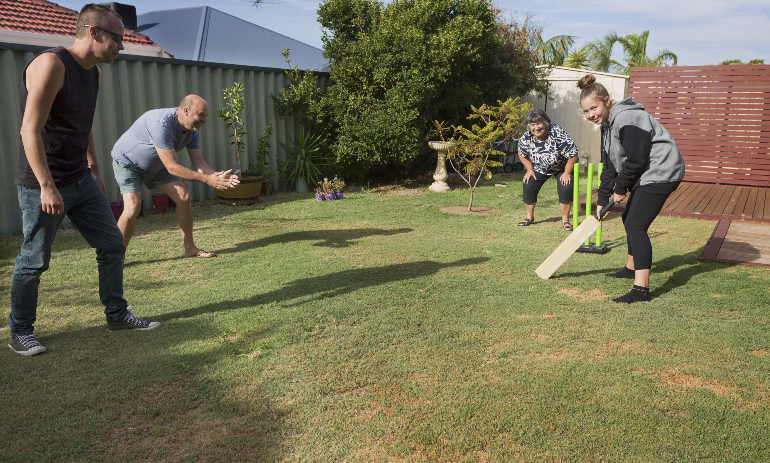 People playing backyard cricket