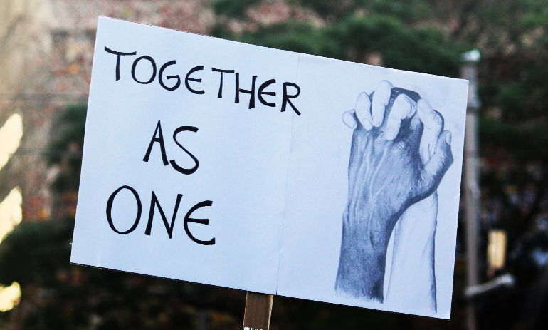 Together as one anti-racism sign