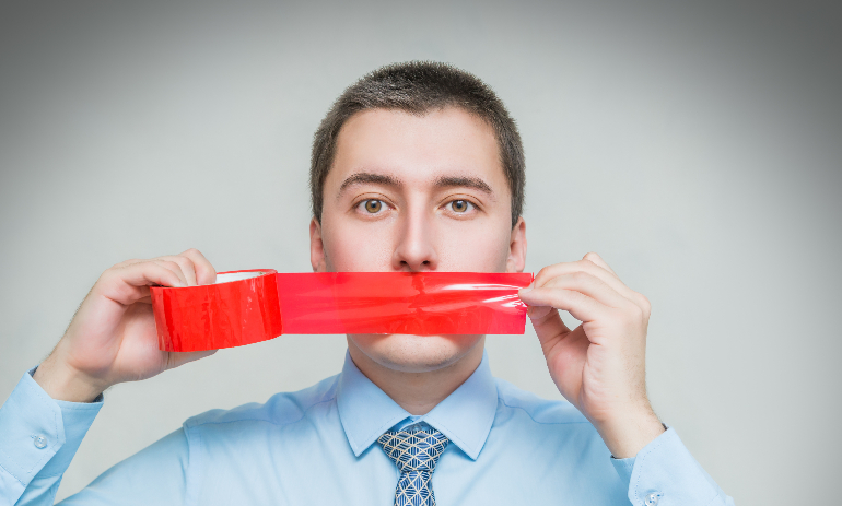 man with wrapping adhesive tape around mouth.