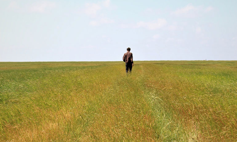 person standing alone in a field