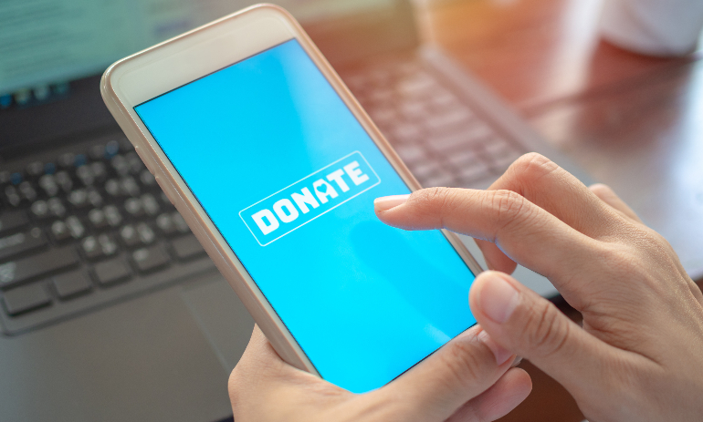Person holding phone with donate button