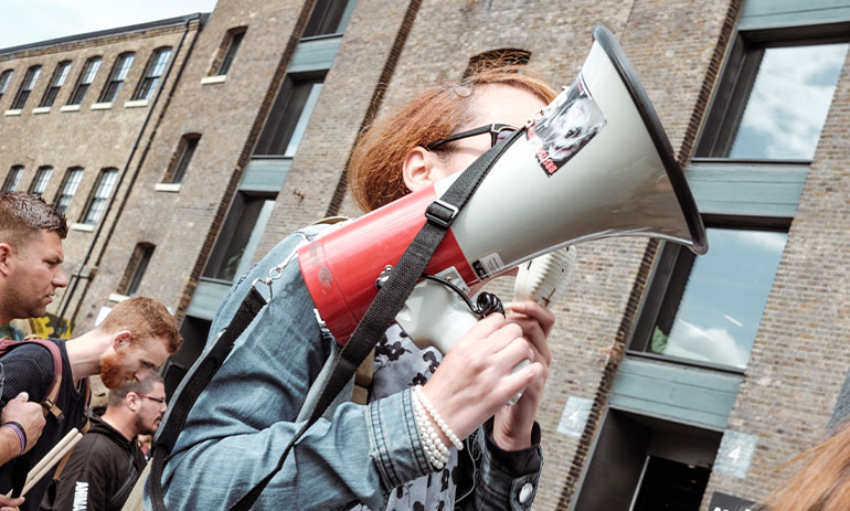 woman holding a megaphone at a protest