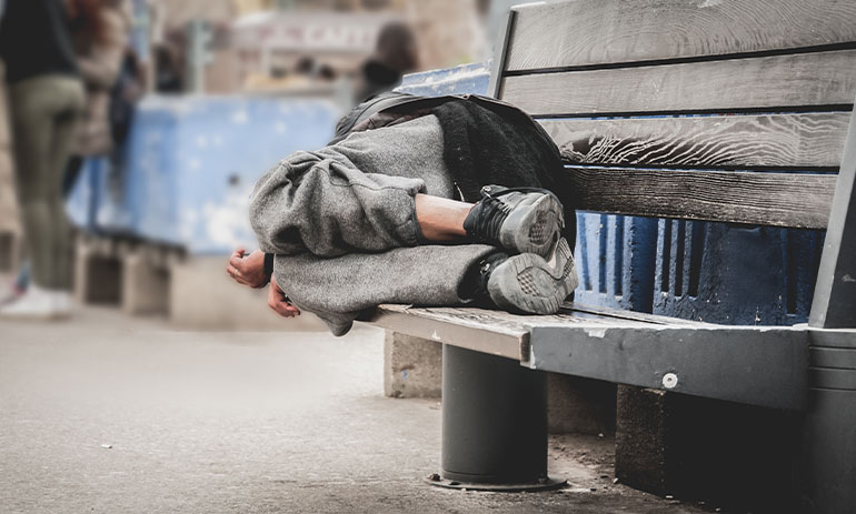 person sleeping on a bench
