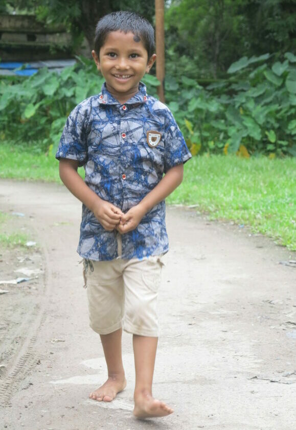 young boy walking and smiling