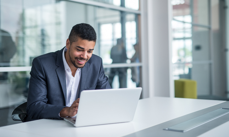 African-American businessman working on a laptop.