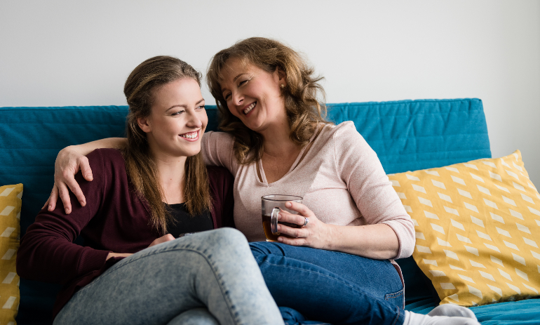 Two women sitting on the couch