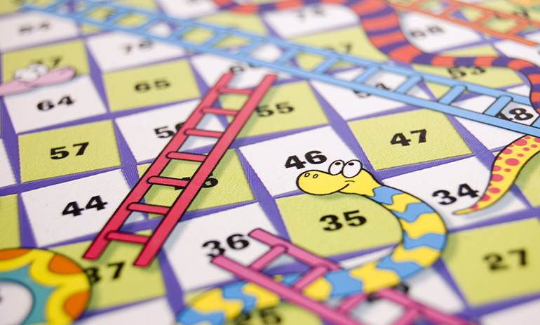 close up of board of snakes and ladders