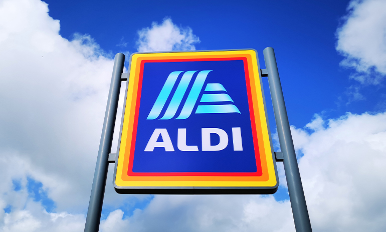 The ALDI supermarket sign is set against a blue sky