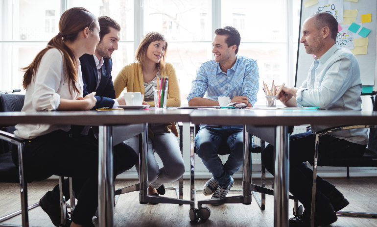 People sitting around table during meeting