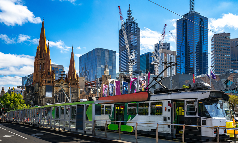 Tram in Melbourne with skyscrapers in the background