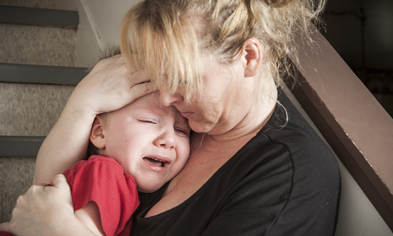 woman comforting crying child