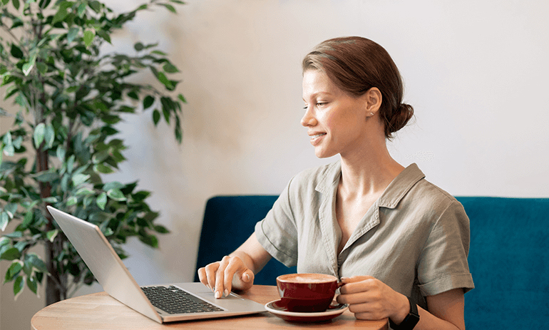 woman on her laptop with a cup of coffee