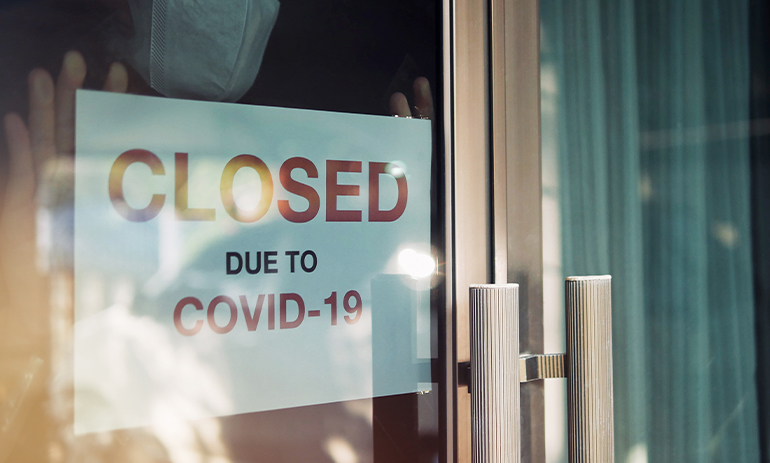 sign in a window saying closed due to COVID 19