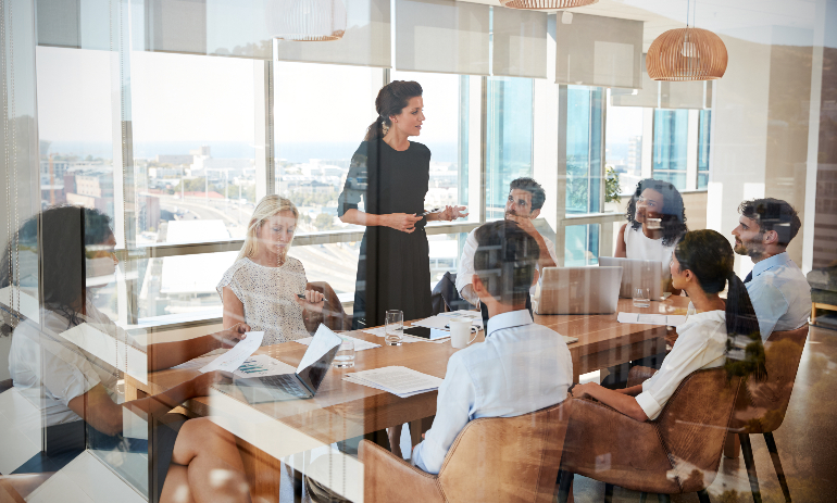 Businesswoman Leads Meeting Around Table
