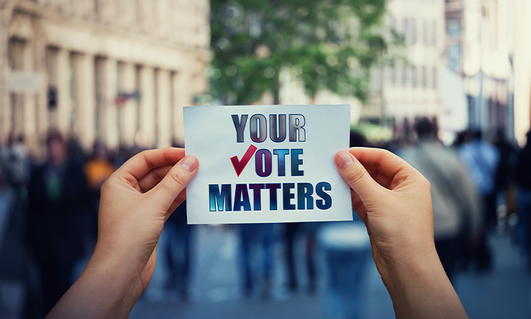 person holding a sign that says your vote matters