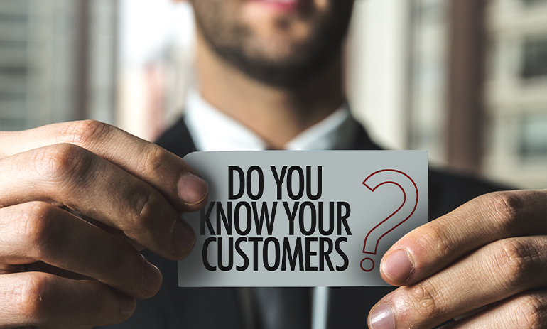 man holding sign that says do you know your customers?