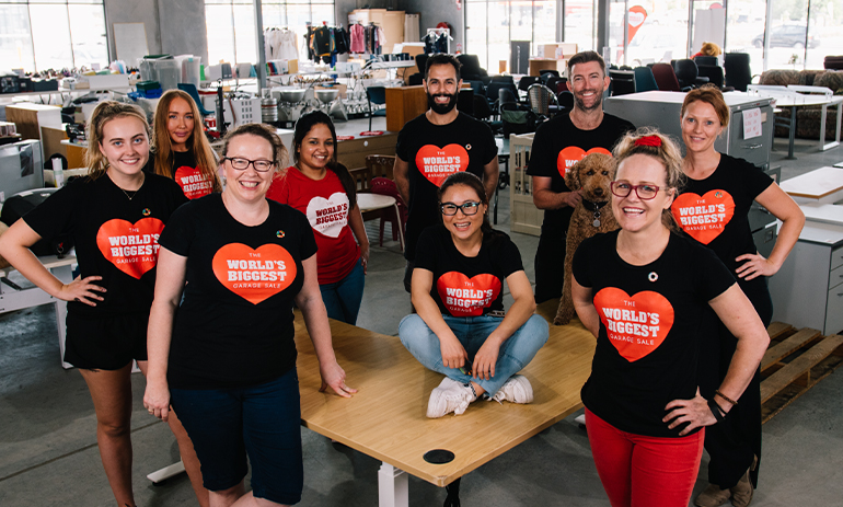 A group of people wear black t shirts with WBGS written in a red heart