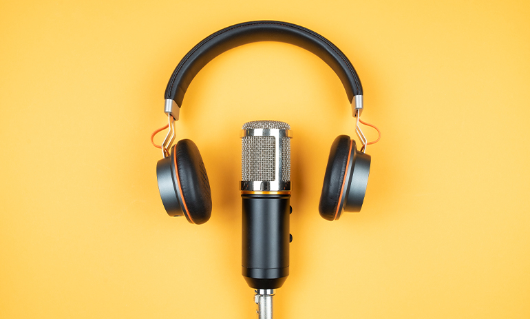 headphones and microphone on yellow background