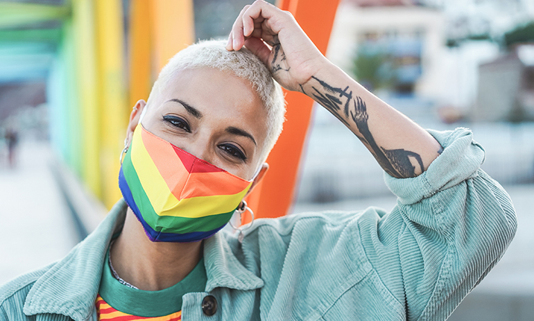 person wearing rainbow flag face mask