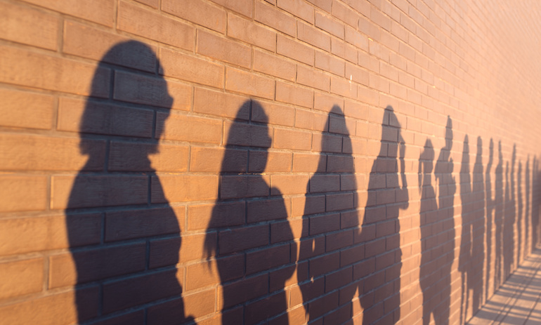 job seekers shadows against a wall