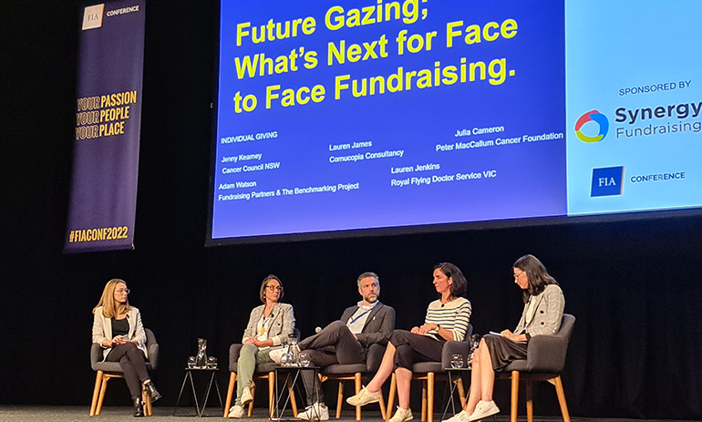 A panel of five people including four women and one man on stage at FIA Conference 2022