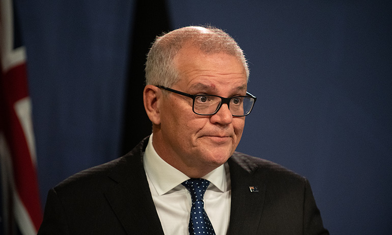 Former Prime Minister Scott Morrison, looking uncomfortable. He is looking off to the side.