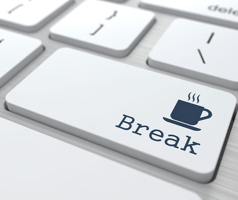 Image of a coffee cup with break wording on a laptop keyboard