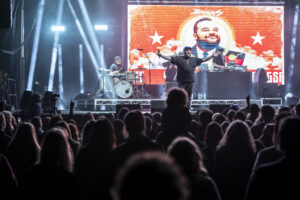 Briggs, an Aboriginal performer, on stage in front of a crowd