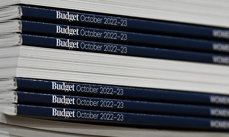A pile of books, some with their spines pointing to the camera, saying 'Budget October 2022-23'