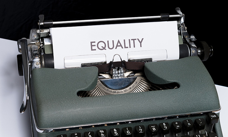 A typewriter with a page in it that says 'equality'