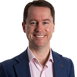 Martin Laverty, a white man with short dark hair, smiles at the camera.