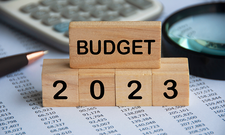 Building blocks reading Budget 2023 on top of financial papers.