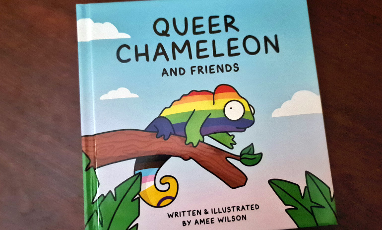 An image of the front cover of Queer Chameleon and Friends, featuring a cartoon chameleon in rainbow striped colours on a brown branch and the text Queer Chameleon and Friends written and illustrated by Amee Wilson.
